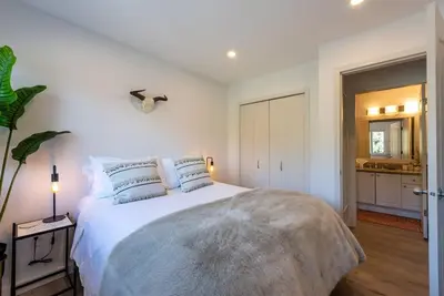 a bedroom with a large white bed with pillows at Location with Views - 2BDR Penthouse Whistler Village in Whistler