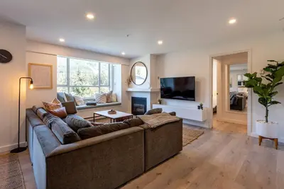 a living room with a couch and a television at Location with Views - 2BDR Penthouse Whistler Village in Whistler