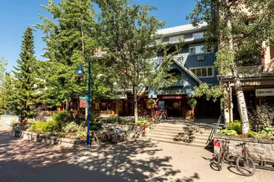 a street with bikes parked in front of a building at Location with Views - 2BDR Penthouse Whistler Village in Whistler