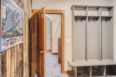 a dressing room with a bench next to a door at Moonshine Crescent 365 by Okanagan Premier in Big White