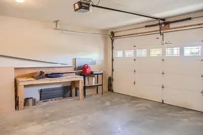 a garage with two garage doors and a table at Moonshine Crescent 365 by Okanagan Premier in Big White