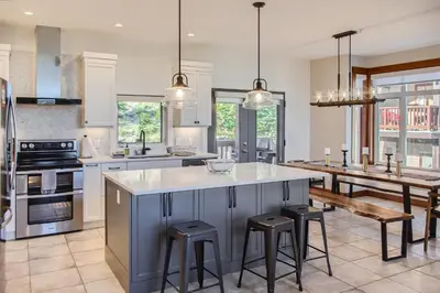 a kitchen with a large island with bar stools at Moonshine Crescent 365 by Okanagan Premier in Big White