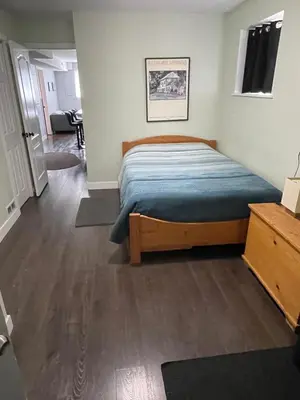 a bedroom with a bed in a room at Hastings Sunrise Experience in Vancouver