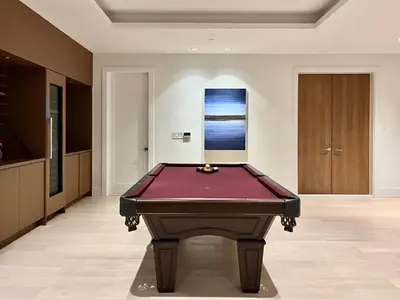 a pool table in the middle of a room at Two King Bedroom w Bath&Living Room in Vancouver