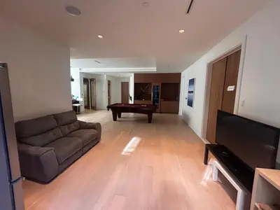 a living room with a couch and a pool table at Two King Bedroom w Bath&Living Room in Vancouver