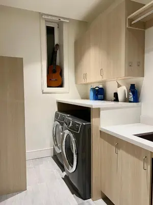 a kitchen with a washing machine and a guitar at Two King Bedroom w Bath&Living Room in Vancouver