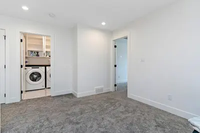 an empty laundry room with a washer and dryer at The Happy place - Luxurious, Cozy and Modern Home with 4 bedroom Air-condition, Netflix, Free Parking close to Airport and West Edmonton Mall in Edmonton