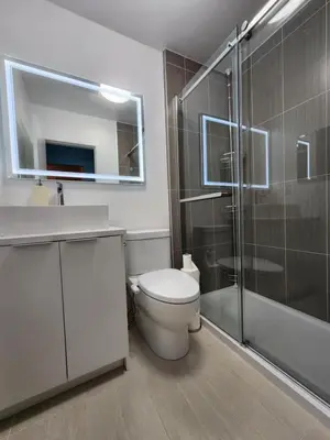 a bathroom with a toilet and a sink and a shower at 2-bed house for downtown, stampede & mountains in Calgary