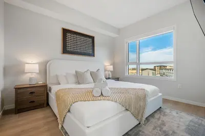 a white bedroom with a bed with a teddy bear on it at Very Spacious Luxury Apartment with AC, 70