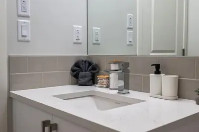 a kitchen counter with a sink in a kitchen at Very Spacious Luxury Apartment with AC, 70