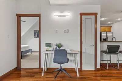 an office with a desk and a chair in a room at Skyline Suite Downtown Canmore Stay in Canmore