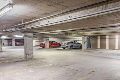 a parking garage with two cars parked in it at Skyline Suite Downtown Canmore Stay in Canmore