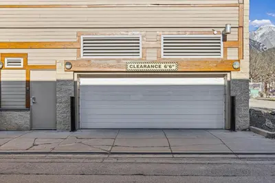 a pair of garage doors on a building at Skyline Suite Downtown Canmore Stay in Canmore