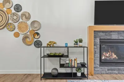 a living room with a shelf with a fireplace at Stylishly Renovated Spring Creek Retreat in Canmore