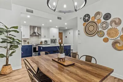 a dining room and kitchen with a wooden table and chairs at Stylishly Renovated Spring Creek Retreat in Canmore