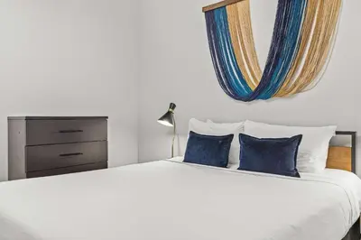 a bedroom with a large white bed with blue pillows at Stylishly Renovated Spring Creek Retreat in Canmore