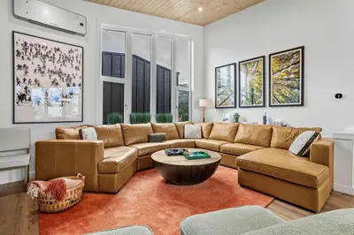 a living room with a couch and a table at Scenic Views in a Luxurious Townhouse in Canmore