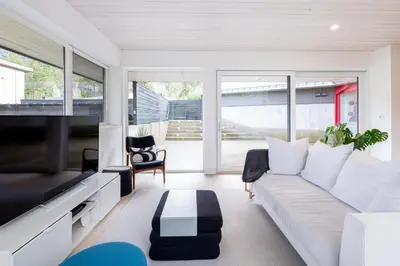 a living room with a white couch and a tv at #9111 Wedgewoods in Whistler