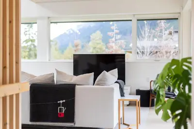 a living room with a couch and a tv at #9111 Wedgewoods in Whistler