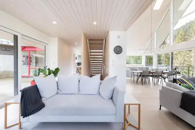 a living room with a white couch and a table at #9111 Wedgewoods in Whistler