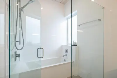 a bathroom with a shower with a glass door at #9111 Wedgewoods in Whistler