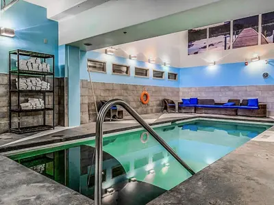 a swimming pool in a hotel room with a pool at Woodland Retreat 2 Bedroom in Canmore