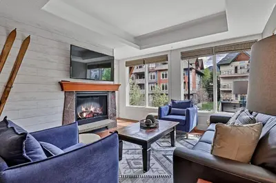 a living room with couches and a fireplace at Classic Hideaway Elegant 2BD 2BTH in Canmore
