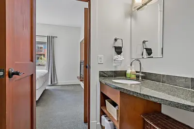 a bathroom with a sink and a mirror at Classic Hideaway Elegant 2BD 2BTH in Canmore
