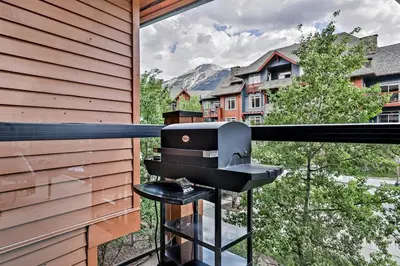 a grill on the balcony of a house at Classic Hideaway Elegant 2BD 2BTH in Canmore