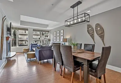 a dining room and living room with a table and chairs at Classic Hideaway Elegant 2BD 2BTH in Canmore