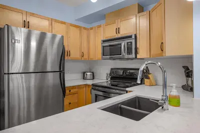 a kitchen with a stainless steel refrigerator and a sink at Family Gateway Outdoor Pool & Hot Tub Experience in Canmore