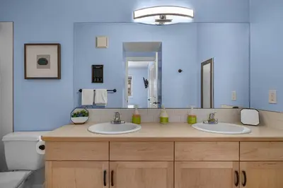 a bathroom with two sinks and a large mirror at Family Gateway Outdoor Pool & Hot Tub Experience in Canmore