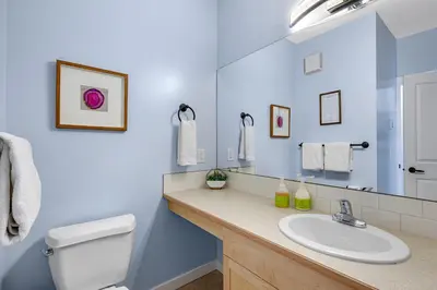 a bathroom with a white toilet and a sink at Family Gateway Outdoor Pool & Hot Tub Experience in Canmore