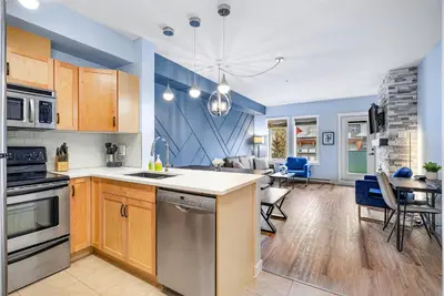 a kitchen and living room with blue walls at Family Gateway Outdoor Pool & Hot Tub Experience in Canmore