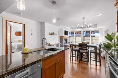 a kitchen with a sink and a table with chairs at Quiet Retreat for Couples in Canmore