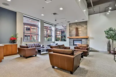 a lobby with leather furniture and a fireplace at Quiet Retreat for Couples in Canmore