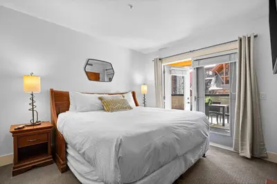 a white bedroom with a bed and a window at Quiet Retreat for Couples in Canmore