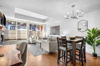 a living room with a table and a dining room at Quiet Retreat for Couples in Canmore
