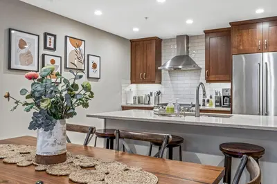 a kitchen with a table with a vase of flowers at Alpine Serenity in Canmore in Canmore