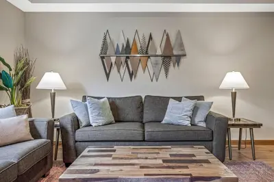 a living room with a couch and a table at Alpine Serenity in Canmore in Canmore