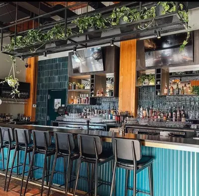 a bar with a bunch of bar stools in a room at Trendy Glenora , Sleeps 10 , Downtown & River Valley adjacent , Jacuzzi tub! in Edmonton