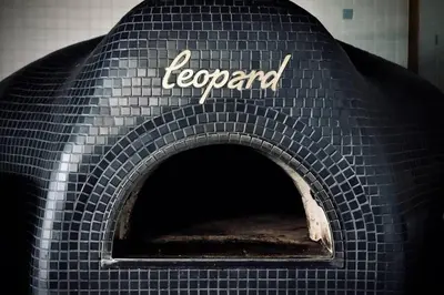 a pizza oven with the word agenda written on it at Trendy Glenora , Sleeps 10 , Downtown & River Valley adjacent , Jacuzzi tub! in Edmonton