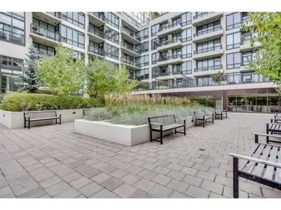 a group of benches sitting in front of a building at Luxury Condo by River with City Views in Calgary
