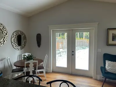 a dining room with a table and a glass door at Bright Spacious Entire Home with Kids Backyard Set in Victoria