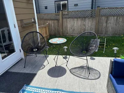 two chairs and a table on a patio at Bright Spacious Entire Home with Kids Backyard Set in Victoria