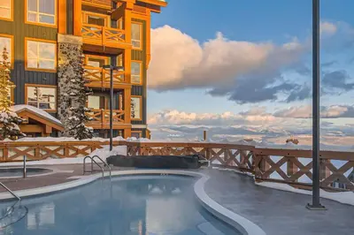 a swimming pool in front of a building at Stonegate Resort Unit B206 in Kelowna