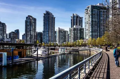 a city skyline with tall buildings and a river at Stunning Skyline Views in a Cozy and Stylish Abode in Vancouver