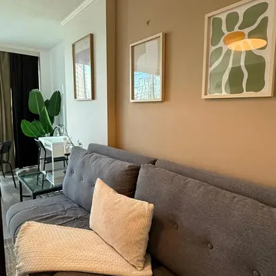 a living room with a couch and a table at Stunning Skyline Views in a Cozy and Stylish Abode in Vancouver