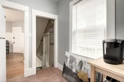 a living room with a large window and a table at Ceruleans 3BR Suite in Calgary in Calgary