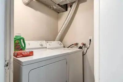 a washer and dryer in a laundry room at Ceruleans 3BR Suite in Calgary in Calgary